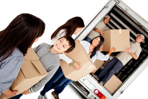 Local moving team handling furniture in a Brixton street