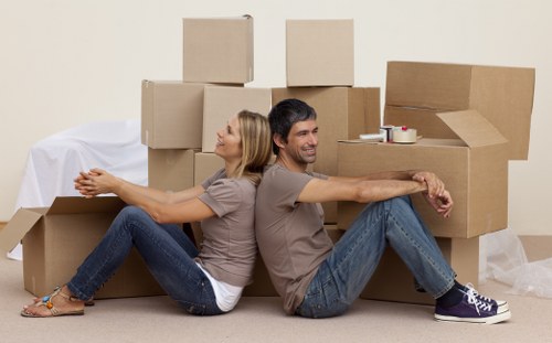 Boxes and furniture being prepared for a Brixton flat relocation