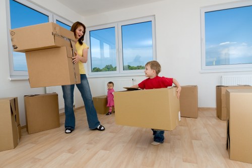 Movers carrying household items from a flat in Brixton