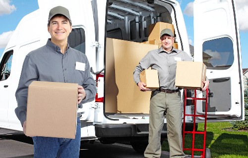 Boxes and household items being loaded into a van for a Brixton move